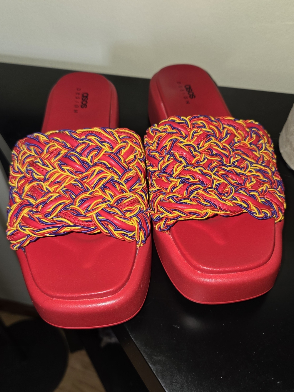 ASOS Design Finbar slide sandals featuring a vibrant, multicolored braided strap